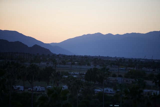 Sun Setting over Majestic Mountains & Palm Trees