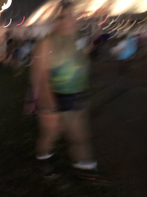 Blurry Nighttime Walk at Music Festival