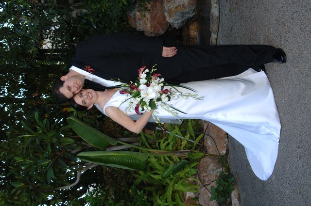 Elegant Bride and Groom Pose in Garden Setting