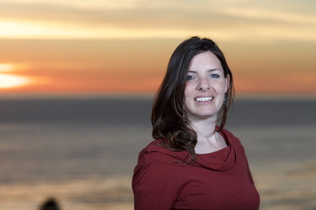 Smiling Woman at Golden Hour Seaside Sunset