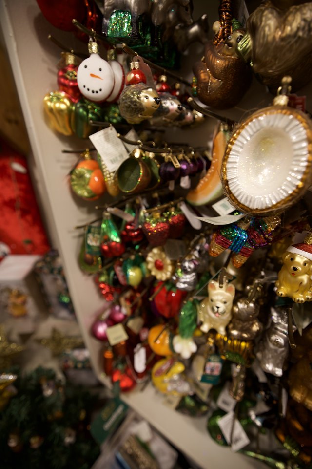Colorful Christmas Ornament Collection Display on White Shelves