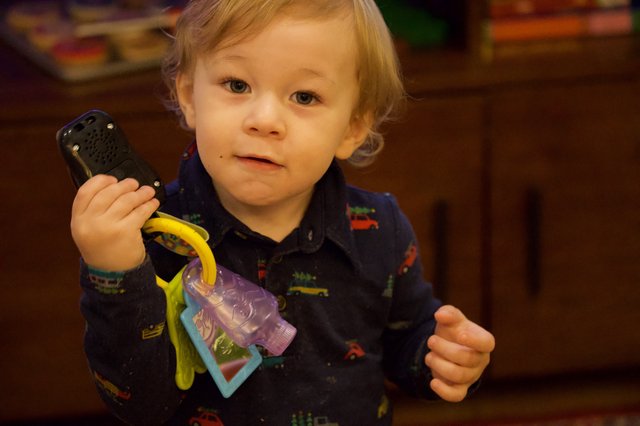 Toddler Playing with Phone and Keys at Christmas Time