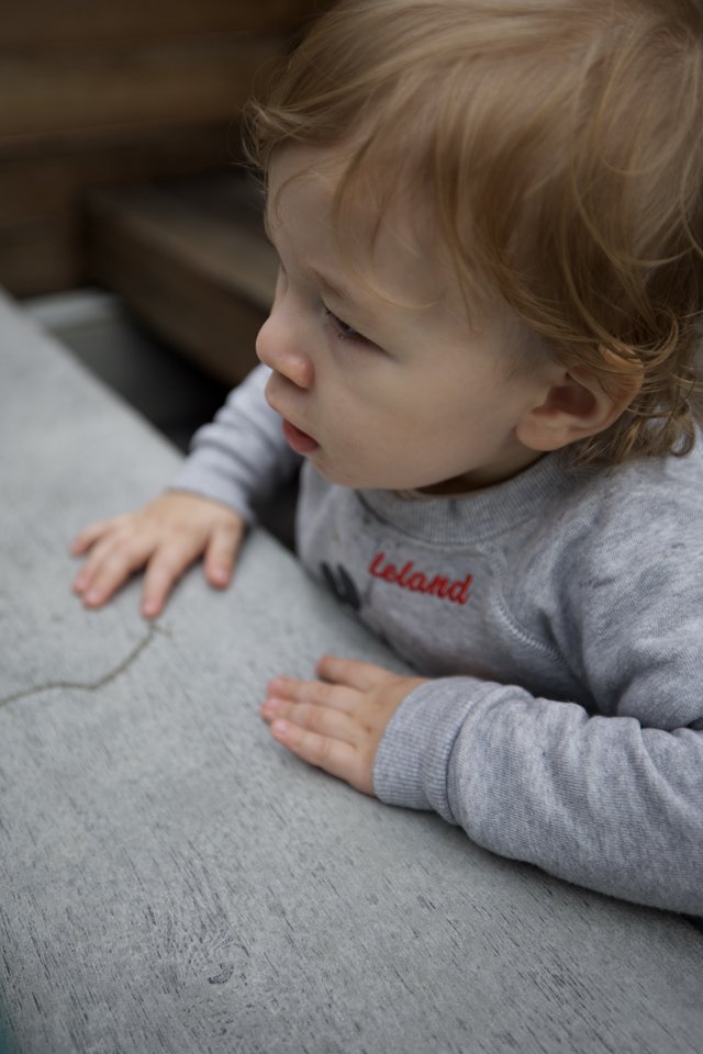 Peaceful Toddler Resting on Gray Couch