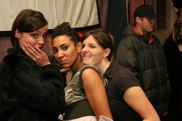 Three Friends Posing Together at Indoor Event