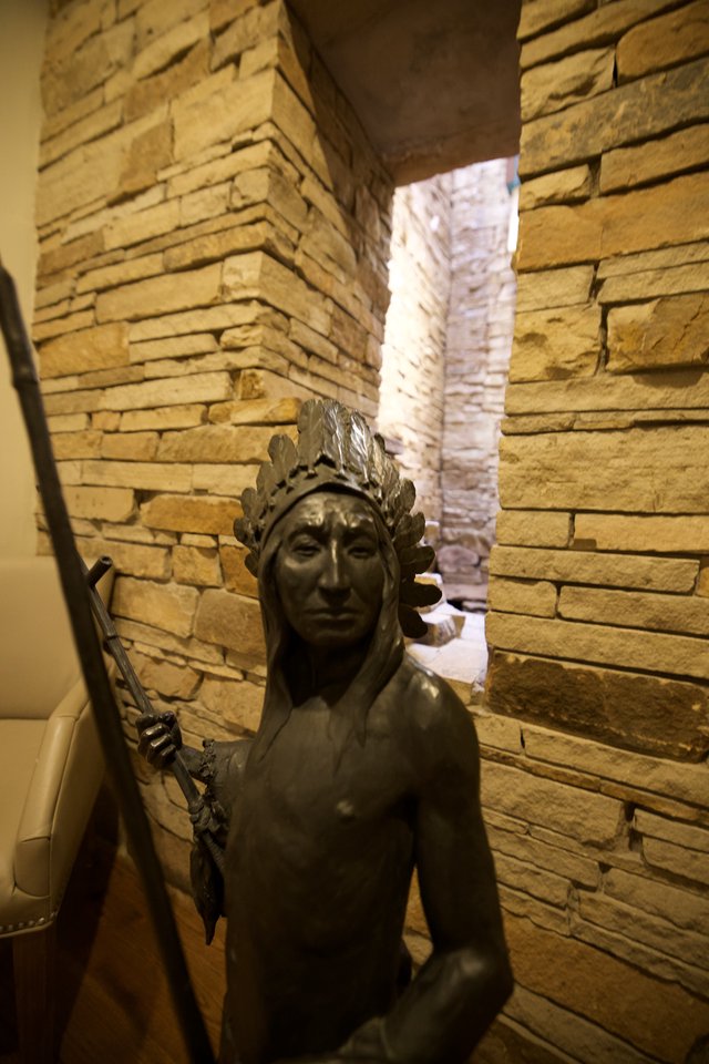 Bronze Statue in Rustic Stone Corridor