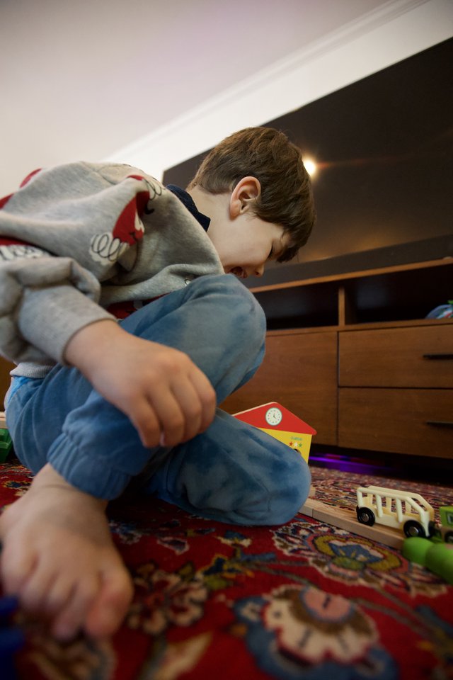 Young Child Playing with Wooden Toys at Home