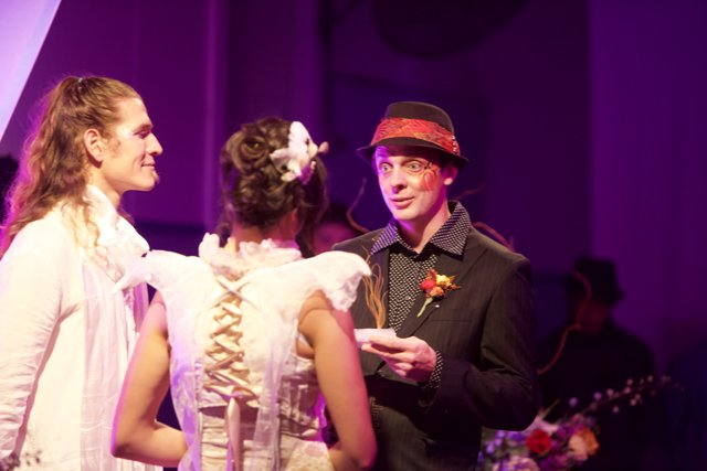 Hat-Wearing Man Chats with Two Women at 2011 Wickstrom Wedding