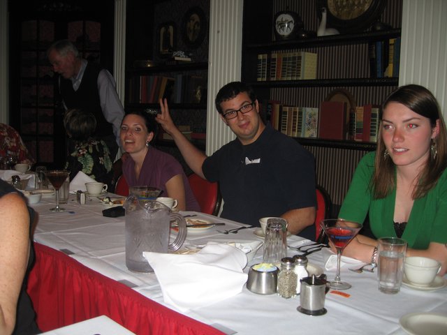 Friends Laughing Together at Restaurant Dinner Table