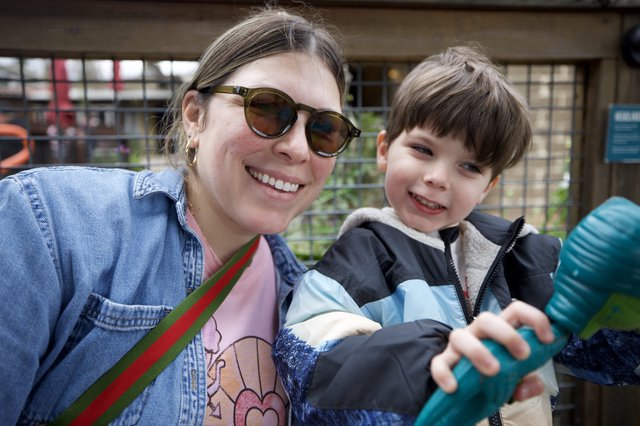 Mother and Son Smiling Together at Outdoor Venue