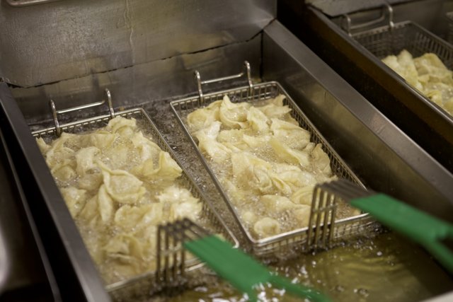 Dumplings sizzling in the fryer