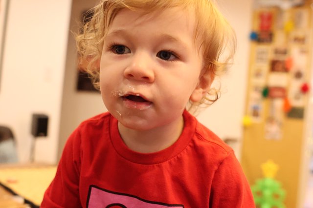 Toddler in Red Shirt After Christmas Meal