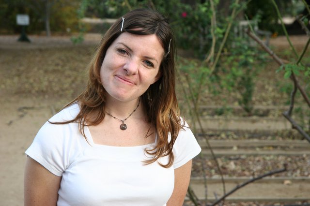 Young Woman Smiling Outdoors in Warm Afternoon Light