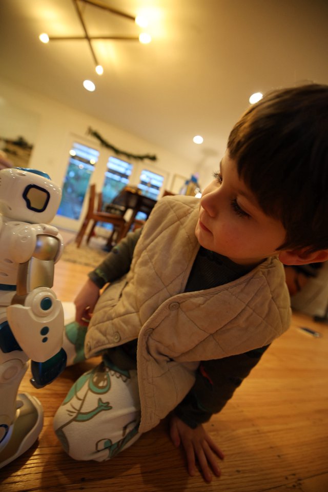 Toddler's Fascination with Interactive Robot Toy at Home