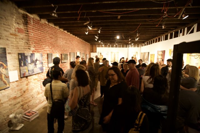 Art Enthusiasts Admire Paintings in Urban Gallery
