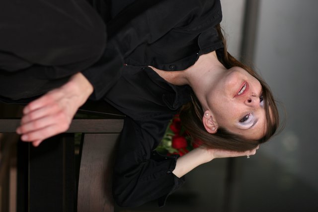 Pensive Woman in Black Gazing Upward Dramatically