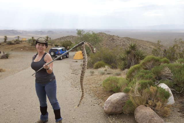 A Teen Girl Tames the Wild: Holding a Snake in the Desert