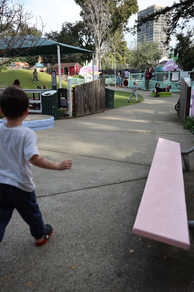 Child Running Through a Community Playground Path