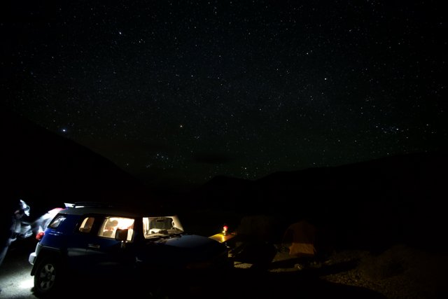 Night Adventure with Two Cars and Starry Skies
