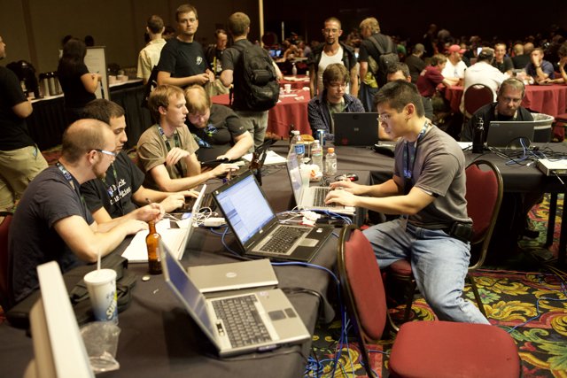 Working Together: A Group of People and Their Laptops