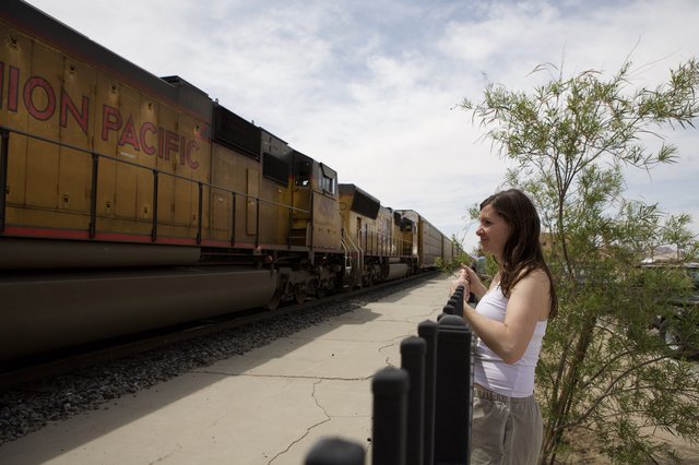 Woman Watches Union Pacific Train Pass in Desert