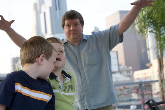 Father Points Out City Sights to Two Young Boys