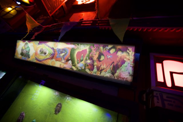 Illuminated Pinball Machine Backglass Display in Arcade