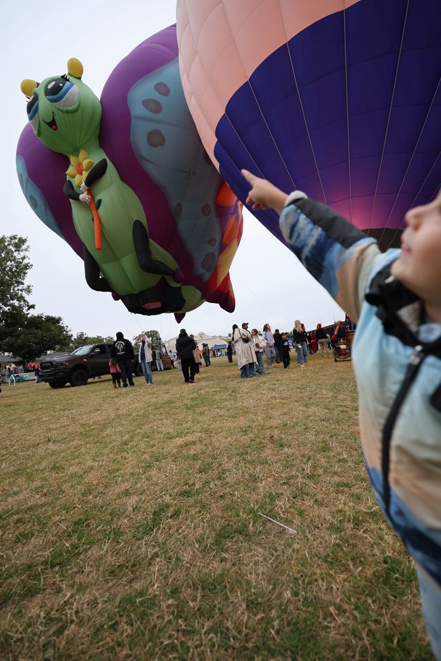 Child Marvels at Caterpillar Hot Air Balloon Festival