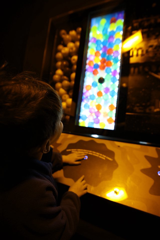 Child Playing Interactive Bubble Game at Science Center