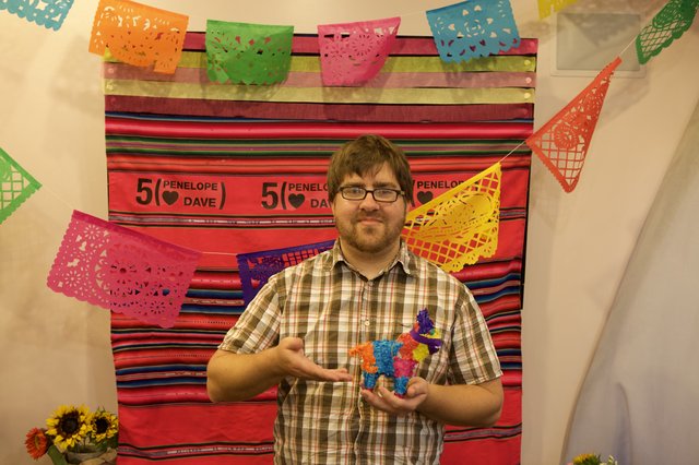 Dave Holds Mini Piñata at Five-Year Anniversary Fiesta