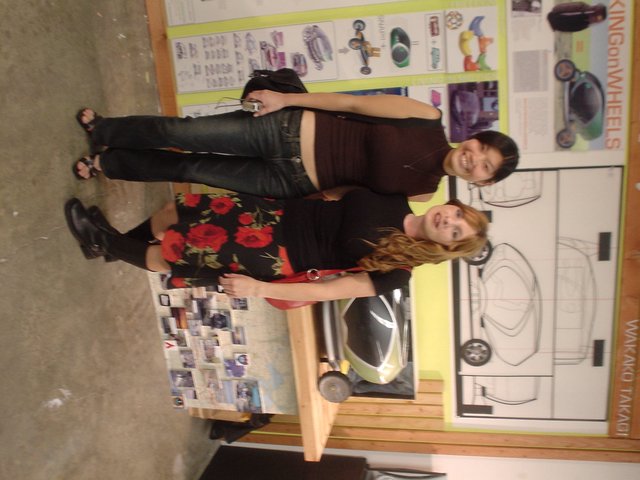 Two Women Posing at Art Exhibition Display