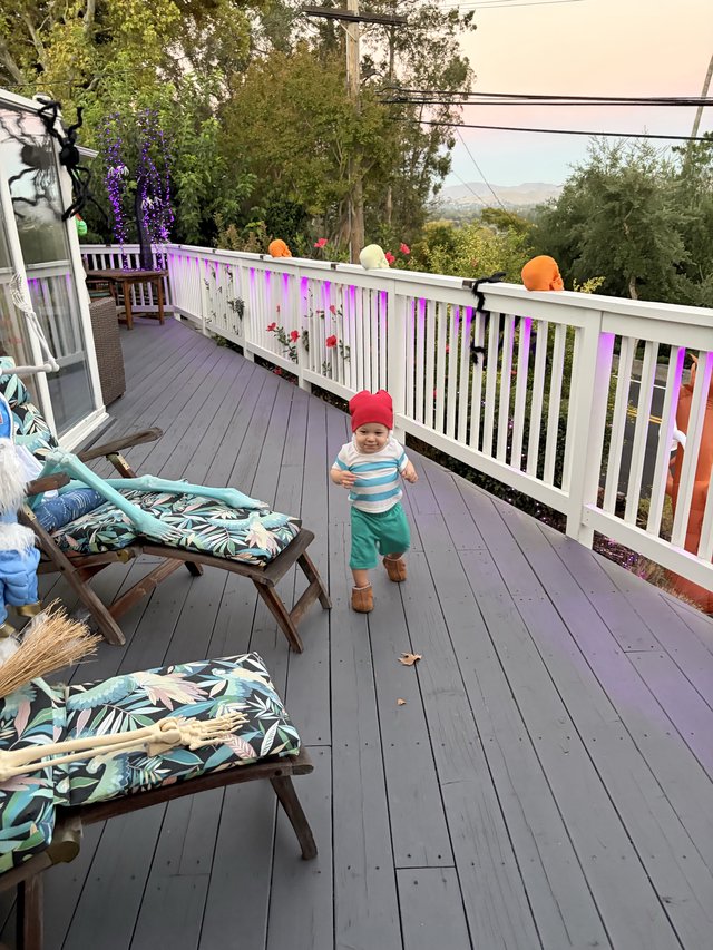 Toddler's Halloween Adventure on Decorated Deck