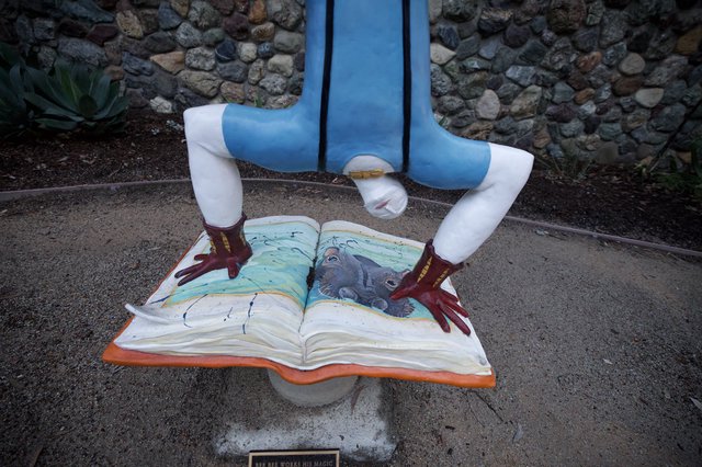 Whimsical Public Art: Reader Standing Over Open Book