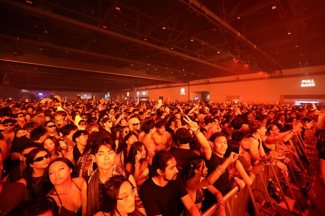 Massive Indoor Crowd Bathed in Red Light