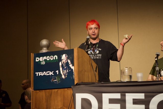 Red-Haired Man Addresses Crowd at Defcon 18 Podium