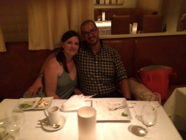 Couple Smiling Together at Restaurant Dinner Table