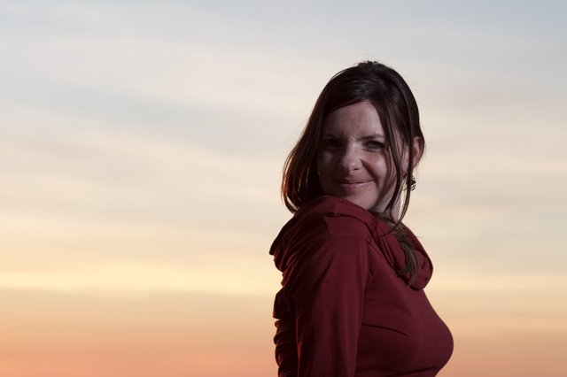 Woman in Red Smiling at Golden Hour Sunset