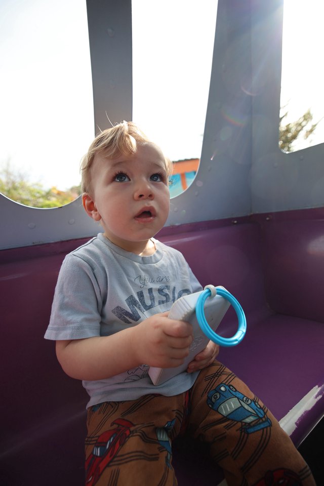 Toddler Looking Up in Wonder at Playground