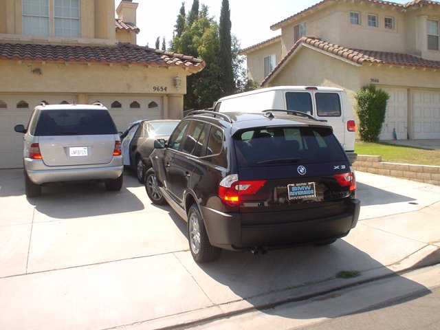 Black SUV parked in front of a single family house
