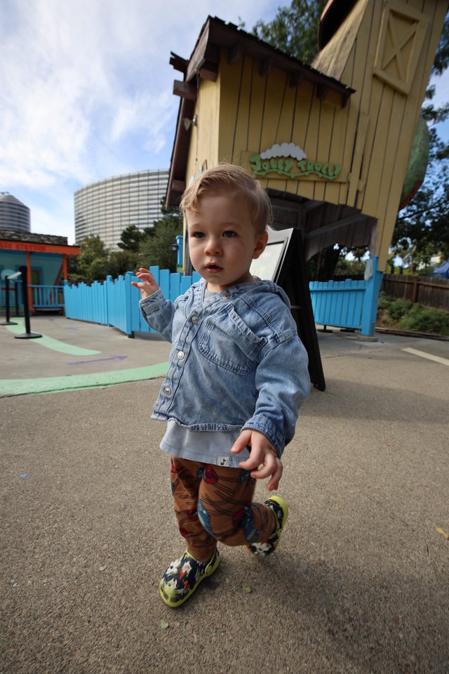 Toddler Exploring Colorful Playground at Theme Park