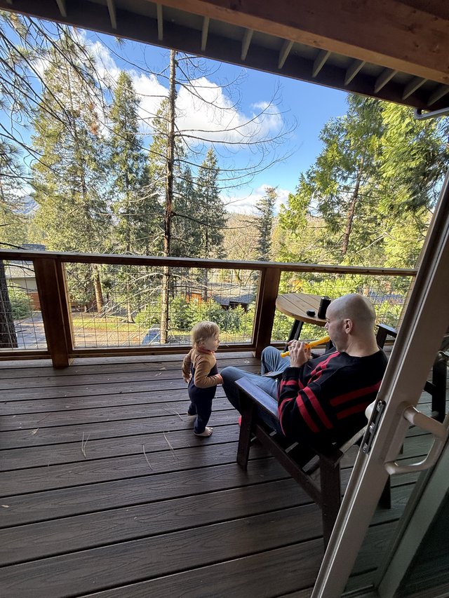 Father and Toddler Share Peaceful Deck Moment