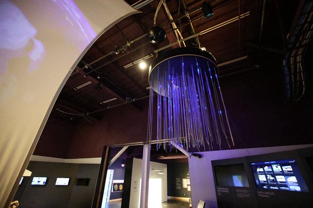 Interactive Space Museum Installation with Purple Fiber Optic Display