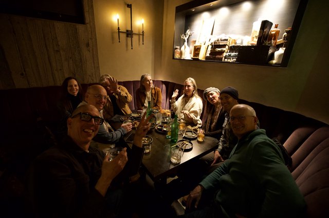 Friends Gathering for Dinner at Cozy Restaurant