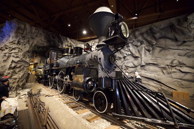 Historic Steam Locomotive Display in Cave-Like Museum Setting