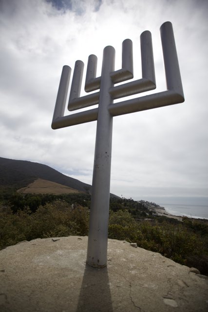 Illuminated Cross on a Hill Overlooking the Ocean