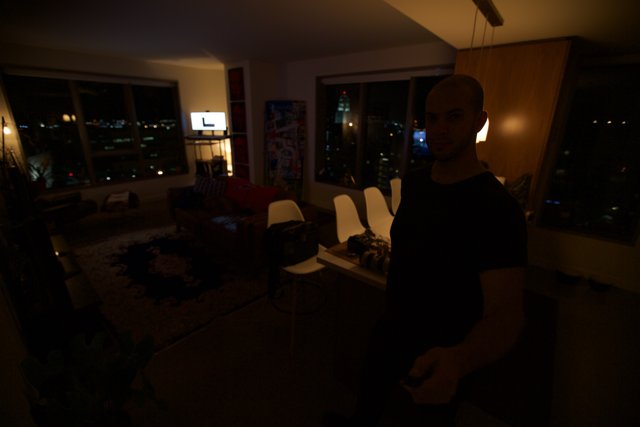 Moody interior shot of a man in a dark room