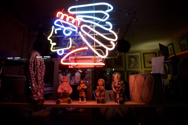 Neon Kokopelli Display with Pueblo Pottery and Folk Art