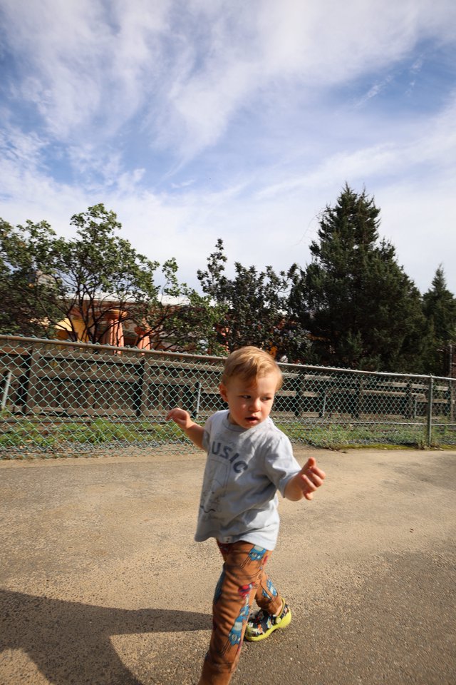 Toddler Running Joyfully at Outdoor Play Area