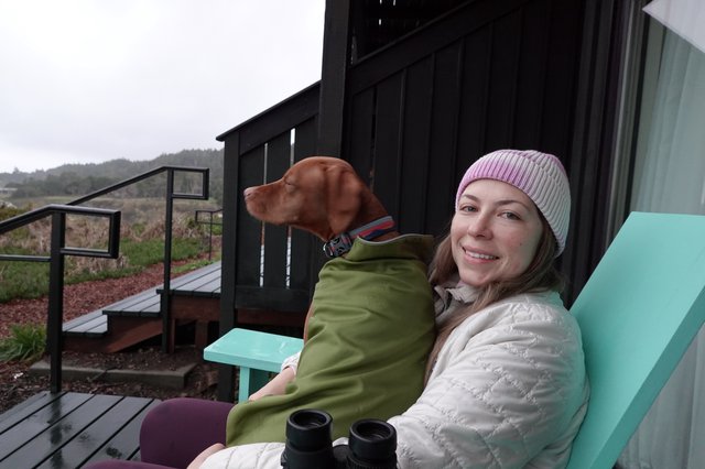 Woman and Dog Relaxing on Coastal Deck