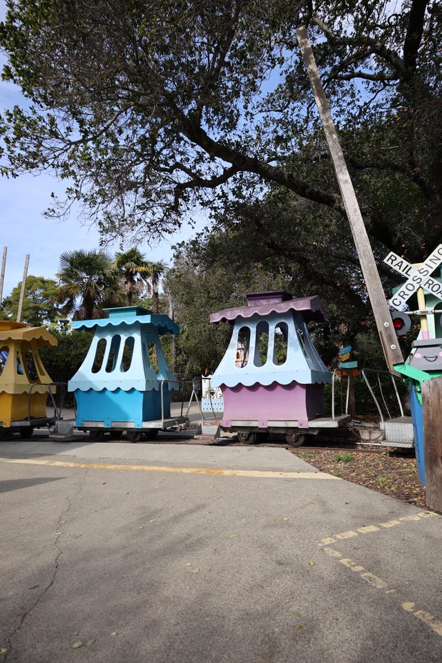 Colorful Miniature Train Stations at Railroad Crossing