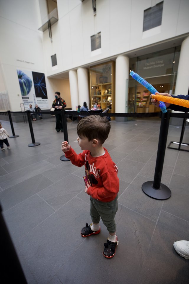 Child Playing with Foam Sword at Asian Art Museum